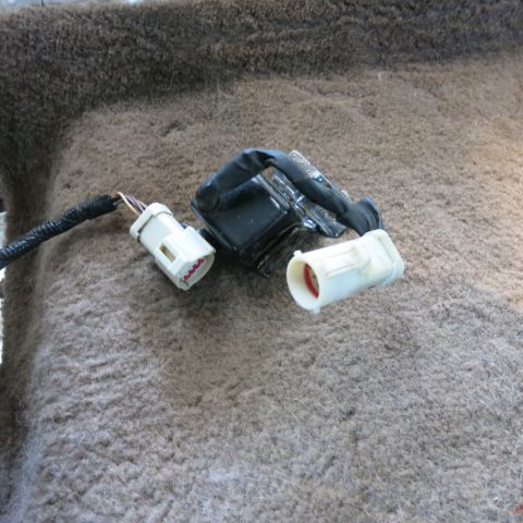 1995 Ford Bronco - Close-up of automotive electrical connectors and wiring harness components on a textured surface.