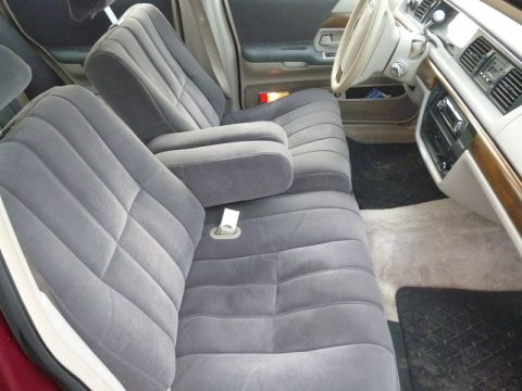 1992 Ford Crown Victoria - The interior of a 1992 Ford Crown Victoria features gray velour seats and wood trim accents.