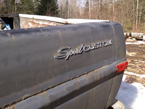 1979 Ford Bronco - Vehicle's rear quarter panel displays "Sport CUSTOM" badging; year is not discernible.