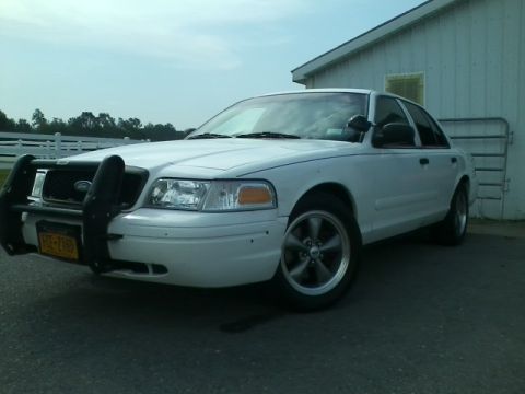 2004 Ford Crown Victoria - This white Ford Crown Victoria is equipped with a push bar and custom wheels.