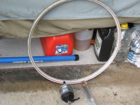 1994 Ford Bronco - Bicycle wheel components are visible along with various containers and a blue tool.