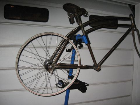 1994 Ford Bronco - A bicycle frame is mounted on a repair stand against a white wall.