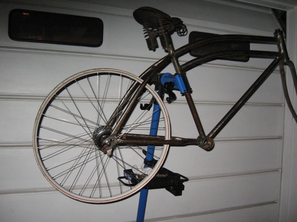 bicycle frame on stand, showing rear wheel and saddle