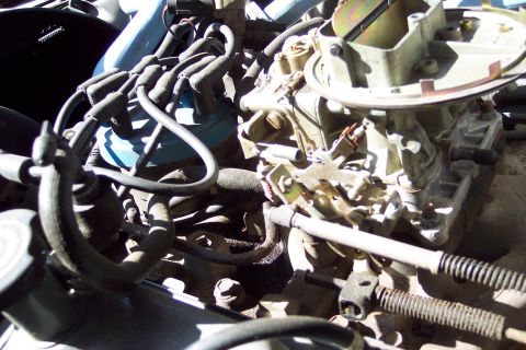 1991 Ford LTD Crown Victoria - Close-up view of engine components, including a carburetor and distributor.