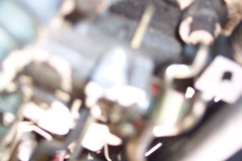 1991 Ford LTD Crown Victoria - Blurry image of engine bay components, possibly from a car.