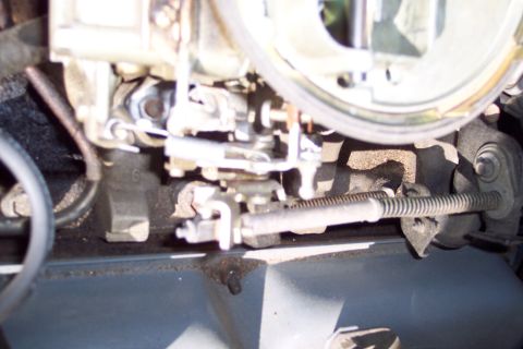 1991 Ford LTD Crown Victoria - Close-up view of carburetor linkage and throttle cable mechanism.