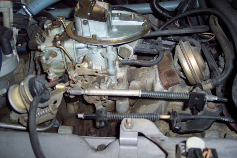 1991 Ford LTD Crown Victoria - Engine bay detail showing a carburetor and associated linkages and hoses.