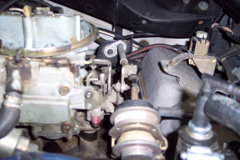 1991 Ford LTD Crown Victoria - Close-up view of an engine's carburetor and associated plumbing.