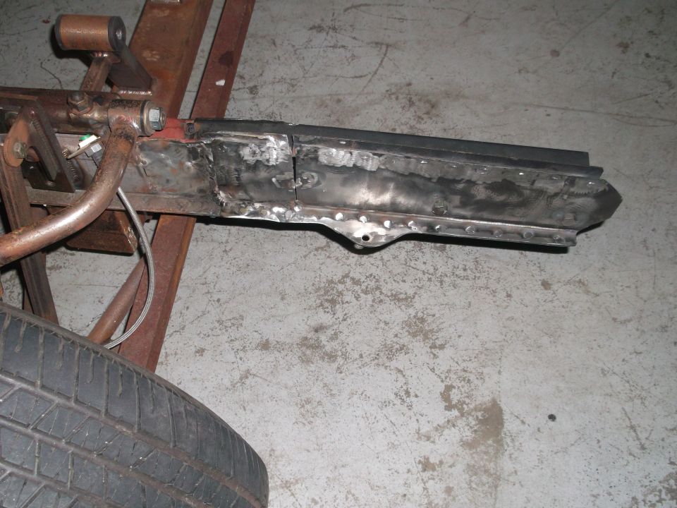 Welded car frame section with tire in foreground
