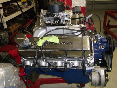 1970 Ford Mustang - A close-up view of a Ford V8 engine with chrome valve covers and a blue painted block.