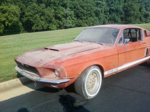 1971 Ford Ranchero - This weathered orange 1967 Ford Mustang GT350 is seen from a three-quarter front angle, parked outdoors.