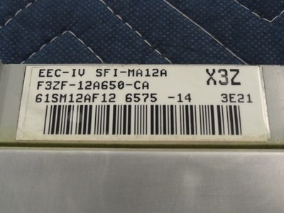 1994 Ford Bronco - A close-up of an engine control module shows part numbers and a barcode.