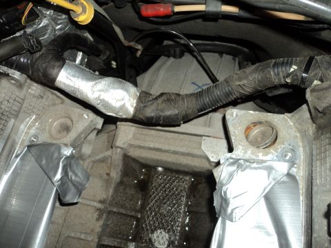 2004 Mercury Grand Marquis - Close-up view of engine bay components, including wrapped wiring and metal parts, with a Supermotors.net watermark visible.
