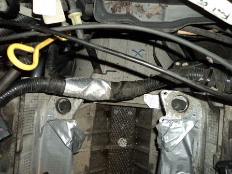 2004 Mercury Grand Marquis - Close-up view of engine bay components and wiring harness, some parts secured with tape.