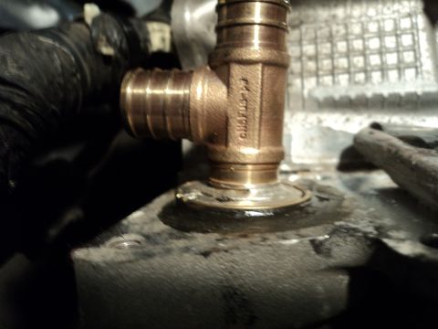 2004 Mercury Grand Marquis - Close-up of a brass plumbing tee fitting attached to an engine block, with a Supermotors.net watermark visible.