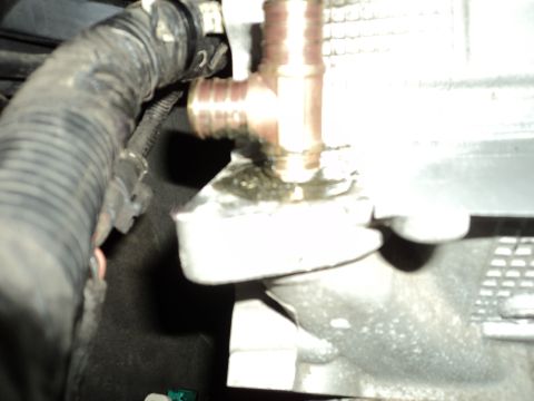 2004 Mercury Grand Marquis - Engine coolant hose fitting with visible fluid leakage.