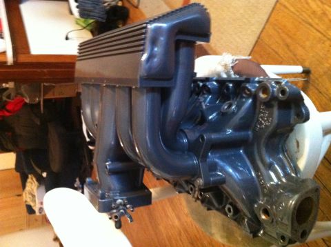 1992 Ford Bronco - Close-up of an engine's intake manifold and cylinder head assembly.