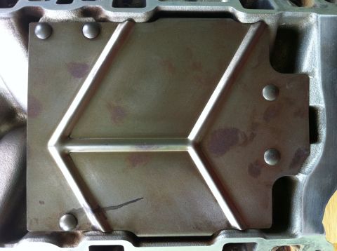 1992 Ford Bronco - Close-up of an engine component a distinctive chevron design and visible rivets.