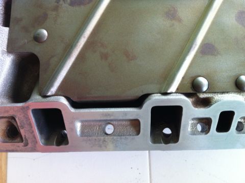1992 Ford Bronco - This is a close-up view of a metal intake manifold part, showing its ports and construction.