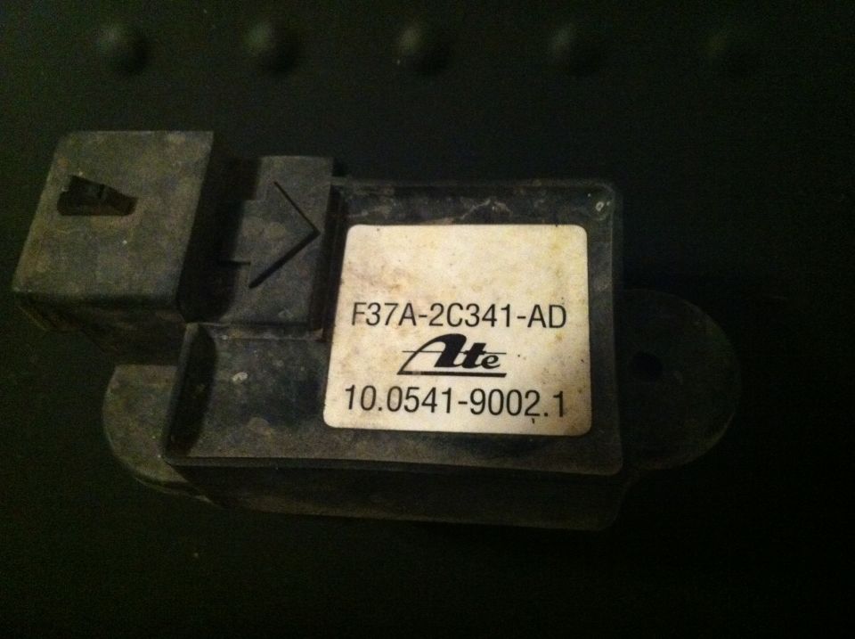 Close-up of a black automotive sensor with a white label showing part numbers F37A-2C341-AD and 10.0541-9002.1, and the Ate logo