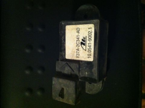 1992 Ford Bronco - A close-up view of an automotive sensor with part numbers visible on its label.
