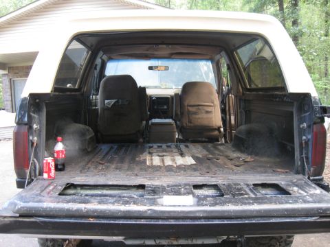 1990 Ford Bronco - View into the rear of a 1990 Ford Bronco, showing the seats and cargo space.