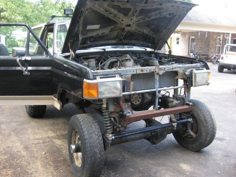 1990 Ford Bronco - This Ford Bronco is undergoing repairs or modifications, with its front end disassembled.