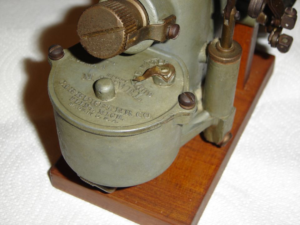 Close-up of a Holley carburetor with "Holley Carburetor Co. Detroit, Mich. Made in U.S.A." visible