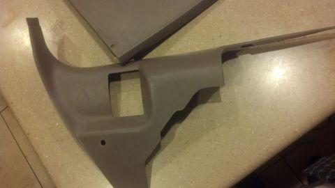1995 Ford Bronco - Gray plastic interior trim piece with a square cutout, likely from a vehicle's dashboard or door panel.