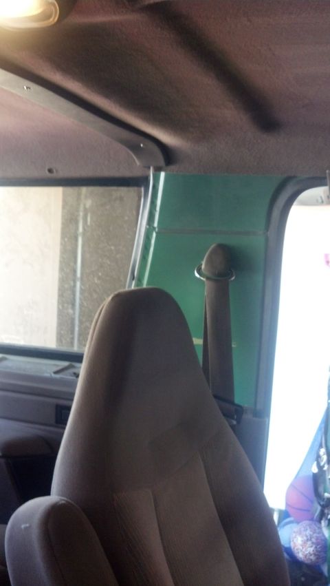 1995 Ford Bronco - The interior of a vehicle is shown, focusing on a seat and the surrounding panels.