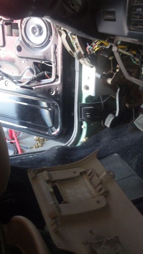 1995 Ford Bronco - The interior of a 1995 Ford Bronco reveals exposed wiring and a removed door panel.