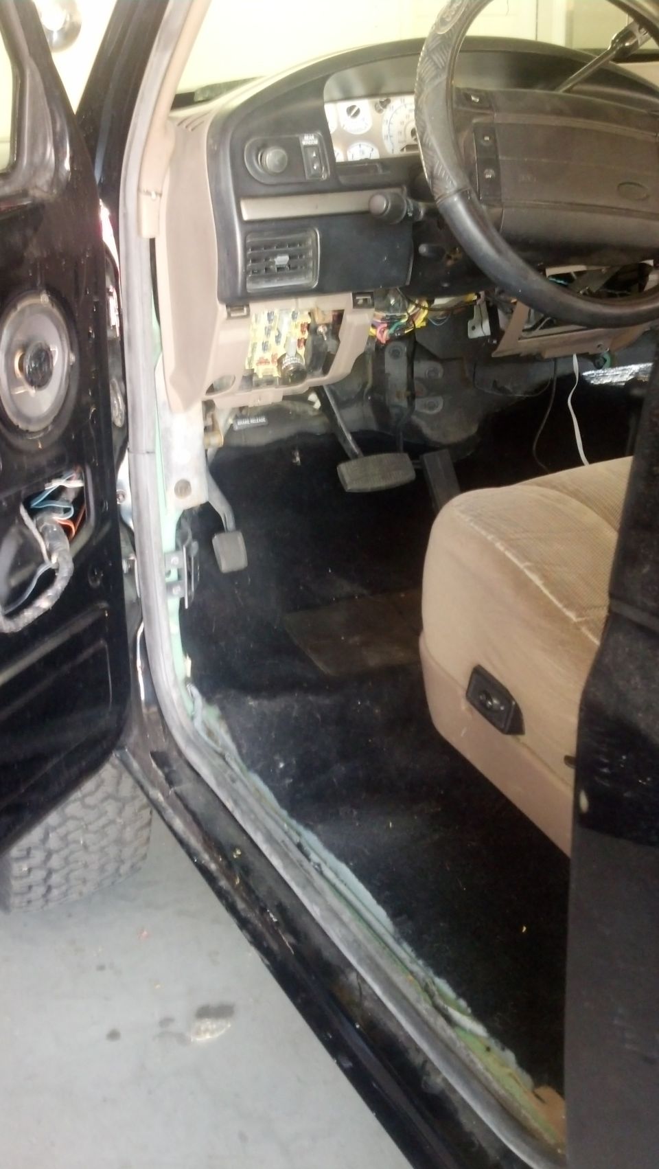 Interior of a 1995 Ford Bronco showing the dashboard and driver's seat