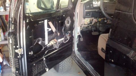 1995 Ford Bronco - Interior view of a disassembled vehicle, revealing internal door mechanisms and dashboard components.