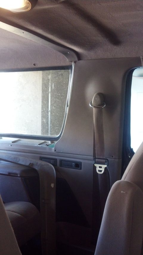 1995 Ford Bronco - Interior shot of a 1995 Ford Bronco, focusing on the rear passenger area and seatbelt.