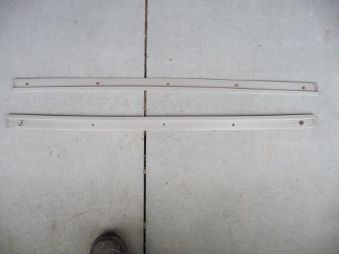 1993 Mazda MX-3 - Two beige side skirts are shown laid out on a concrete surface.