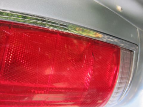 1991 Ford LTD Crown Victoria - Close-up of a scratched taillight on a silver 1991 Ford Crown Victoria LTD.