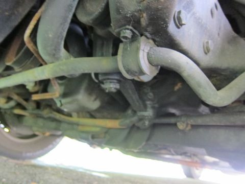 1991 Ford LTD Crown Victoria - A close-up view of the undercarriage reveals suspension components like the sway bar and various hoses.
