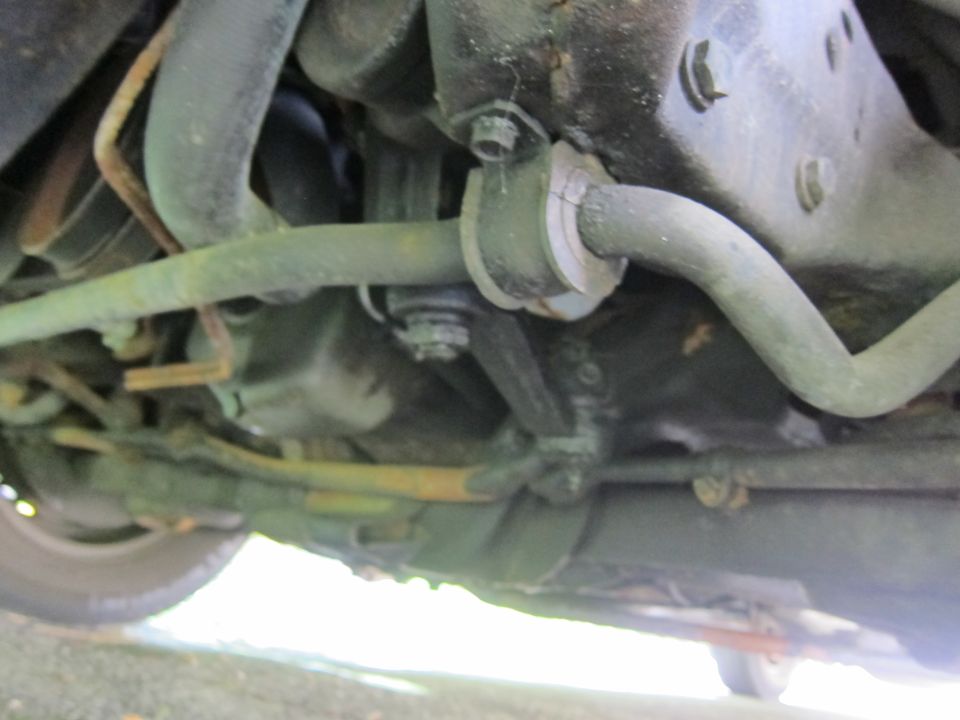 Undercarriage view of suspension components, including sway bar and hoses
