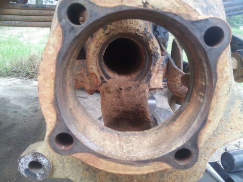 1988 Ford Bronco - This is a close-up view of a heavily corroded vehicle axle housing, showing significant rust and wear.