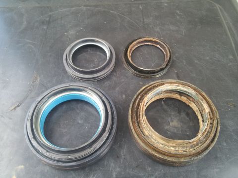 1988 Ford Bronco - Comparison of new and old wheel bearing seals, highlighting wear and tear on the older components.