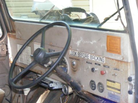 1978 Ford Bronco - Dashboard interior of an older vehicle, showing the steering wheel, gauges, and various switches.