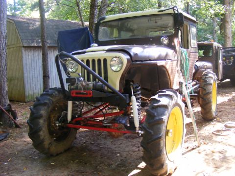 1978 Ford Bronco - Customized Jeep CJ-5 large tractor tires and a winch, parked outdoors.