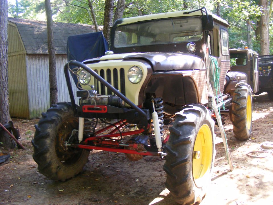 Modified Jeep CJ-5 with large tractor tires and custom front bumper with winch