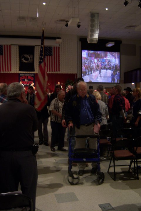 1979 Ford Bronco - An indoor gathering with American flags displayed and a large screen showing a live event.