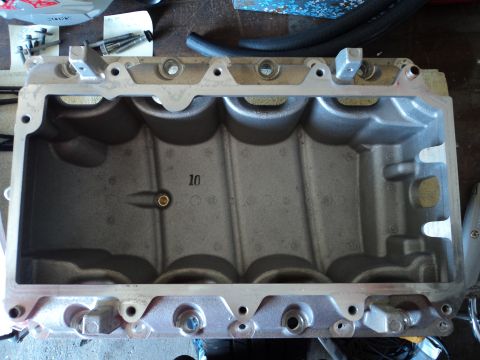 2004 Mercury Grand Marquis - An engine intake manifold, possibly from a Mercury Grand Marquis, is shown with casting marks and bolt holes.