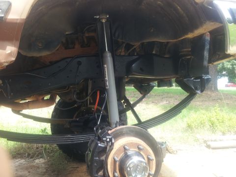 1988 Ford Bronco - Undercarriage view showing leaf springs and a shock absorber, with visible text on the shock.