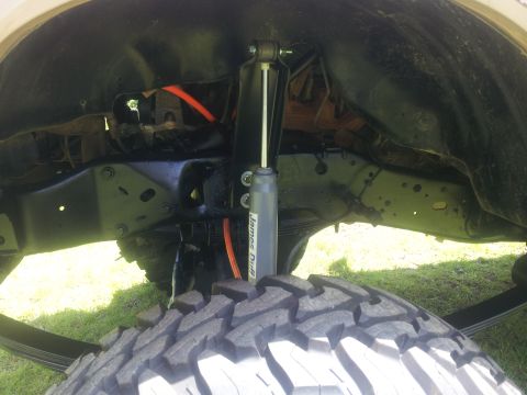 1988 Ford Bronco - Rear suspension components and a large off-road tire are visible in this close-up shot.