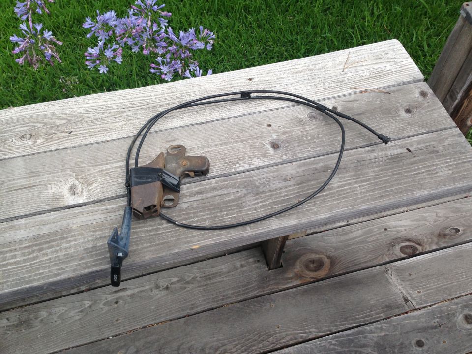 Hood latch cable assembly with black cable and metal bracket