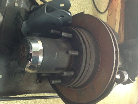 1986 Ford Bronco - Ford Bronco hub assembly and brake rotor detail. Part of the suspension system is visible.