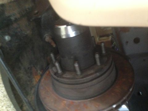 1986 Ford Bronco - This image shows a close-up view of a vehicle's hub assembly and brake rotor, with some suspension components visible.